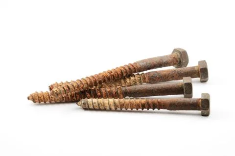 Four rusty screws on a white Stock Photos