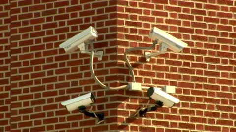 Four security surveillance cameras on a brick building Stock Footage 22148736