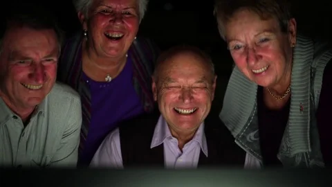 Four senior friends in front of computer laughing Stock-Footage 83030221