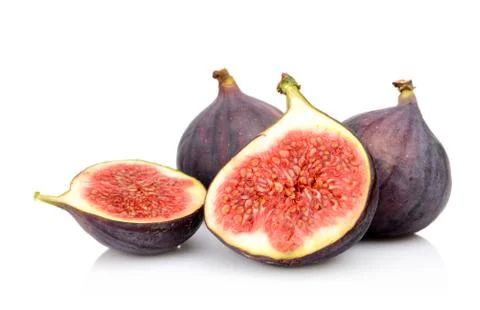 Four sliced figs lengthwise in half, isolated on white background Stock Photos