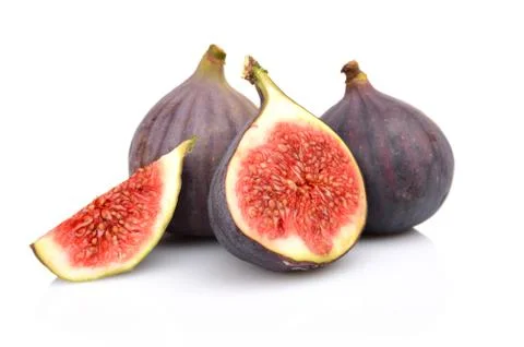 Four sliced figs lengthwise in half and quarter, isolated on white background Stock Photos
