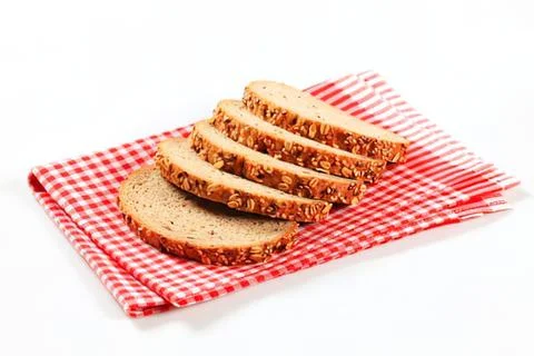 Four slices of toasted bread on checkered cloth 스톡 사진