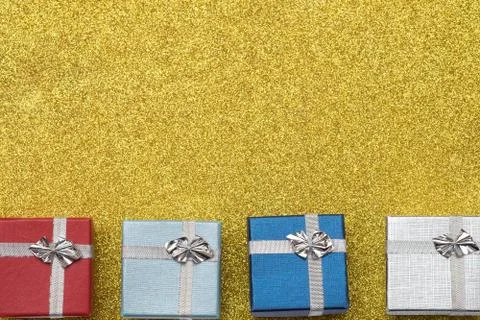 Four small box on yellow background Stock Photos