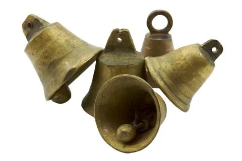Four small brass or bronze bells  leaning on one another Stock Photos
