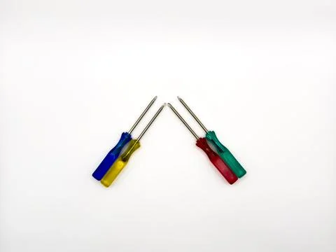 Four small colored plastic screwdrivers on a white background. copy space, flay Stock Photos