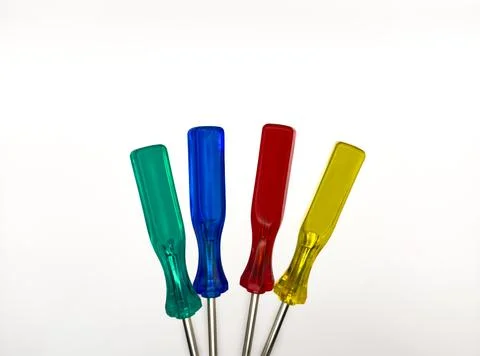 Four small colored plastic screwdrivers on a white background. copy space, flay Stock Photos