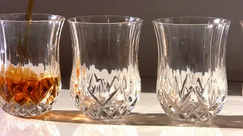 Four small decorated and lined glasses that fill with whiskey Video stock 110268116