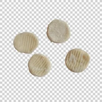 Four small round crackers with textured ridges isolated on a transparent ba.. Фото