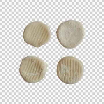 Four small round pieces of raw potato gnocchi pasta isolated on a plain bac.. Фото