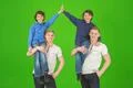 The four smile brothers stand on the green background Photo