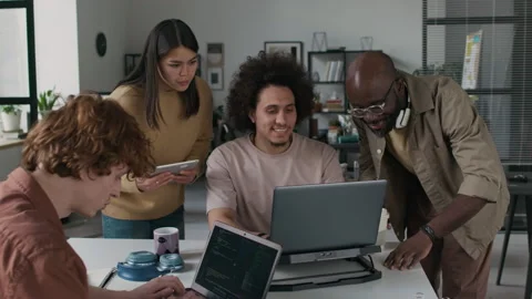 Four Software Developers Working on Collaborative Project in Corporate Office Stock Footage 299253101