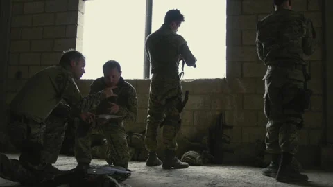 Four Soldiers checking weapons indoors Stock Footage 275094193