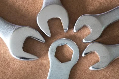 Four spanner of different size lying in the direction of the hex-key Stock Photos