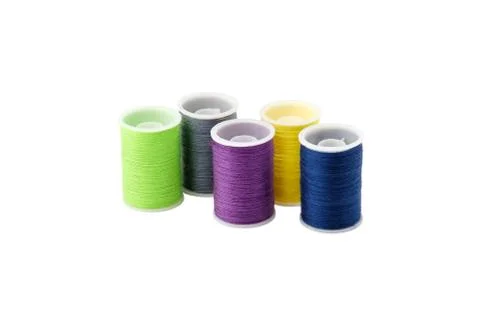 Four spools with multi-colored threads isolated on a white background. Stock Photos