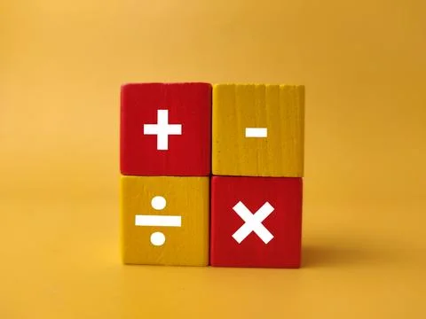 Four square colored blocks are arranged in a grid displaying white mathemat.. Stock Photos