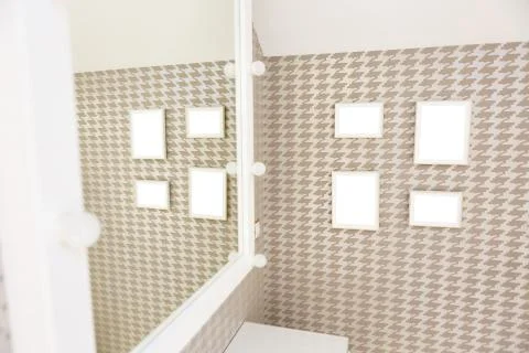 Four square photo frames on the wall with the ability to insert your own imag Stock Photos