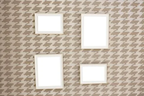 Four square photo frames on the wall with the ability to insert your own imag Stock Photos