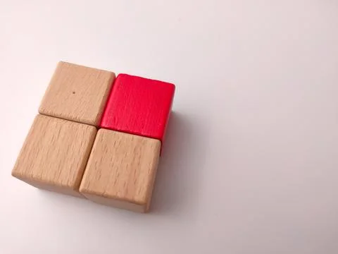 Four square wooden blocks form a grid, showing three natural finishes and o.. Stock Photos