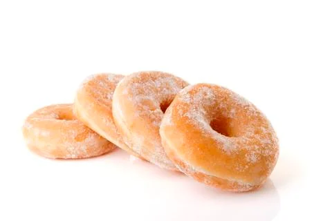 Four stacked sugared donuts over white background Foto stock