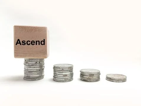 Four stacks of silver coins in increasing height with a wooden block featur.. Stock Photos