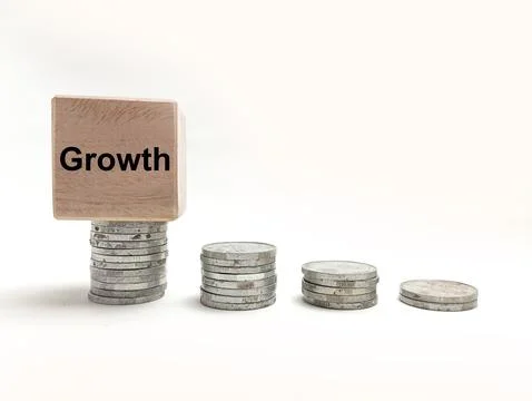 Four stacks of silver coins in increasing height with a wooden block featur.. Stock Photos