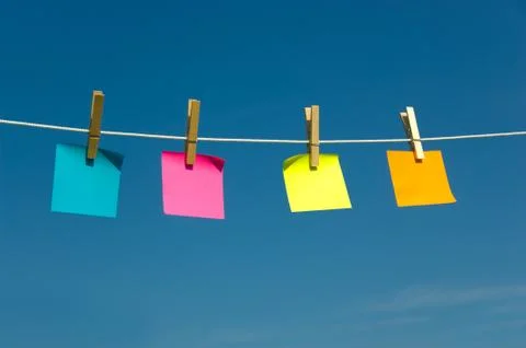 Four sticky notes on a clothesline Stock Photos