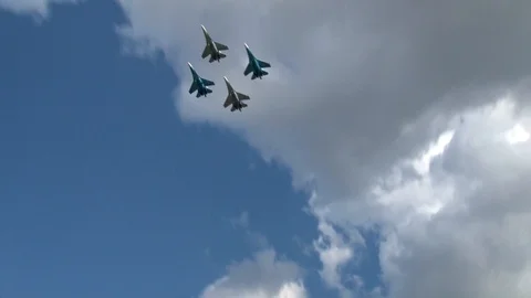 Four Su-27SM multi-purpose aircraft (NATO: Flanker-B) perform aerobatics. Stock Footage 116318638