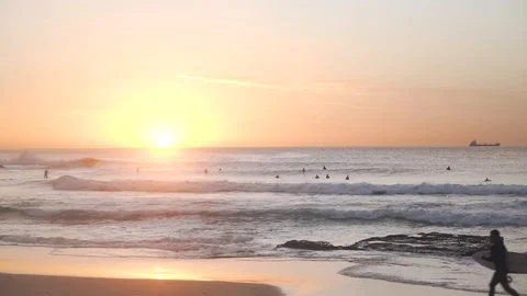 Four surfers run with boards Stock Footage 107048965