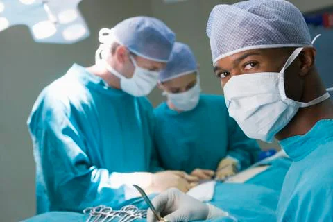 Four Surgeons Getting Ready To Operating On A Patient Stock Photos