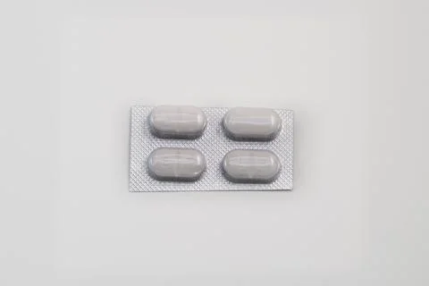 Four tablets in a blister pack on white background 스톡 사진