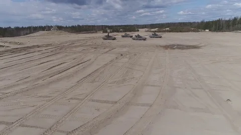 Four tanks stand still on the ground Stock Footage 76838436