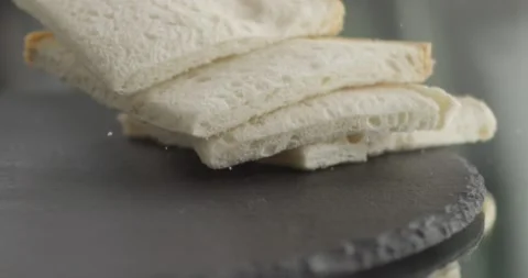 Four toasts fall on a black surface Stock Footage 200937589