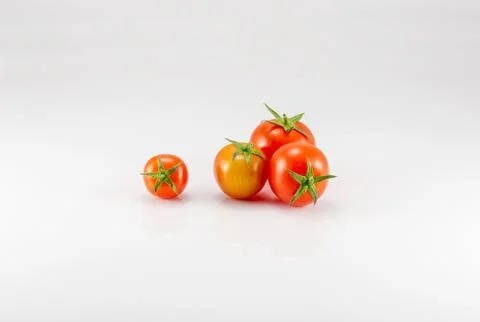 Four tomatoes on the white background Foto stock