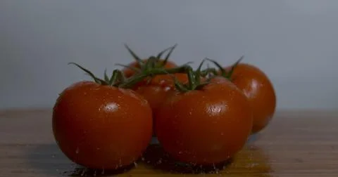 Four Tomatoes on a Wooden Table Stock Photos