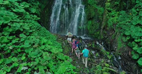 Four tourists are coming to stream falling from great height with channel Stock Footage 209126830