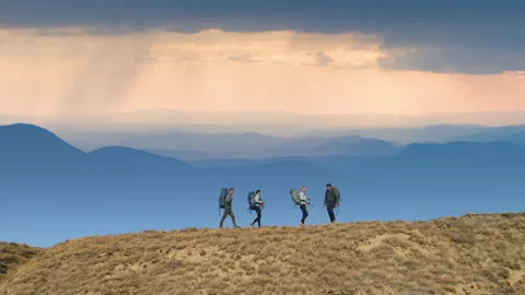 The four tourists walking on the mountain range Stock Footage 141031765
