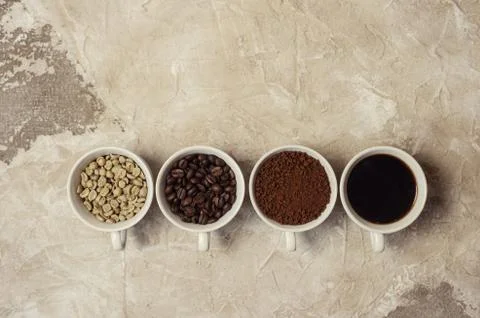 Four types of coffee unroasted, bean, ground and one in cup Stock Photos