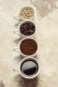 Four types of coffee unroasted, bean, ground and one in cup Stock Photos