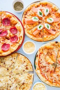 Four types of pizza set background. Top view. Stock Photos