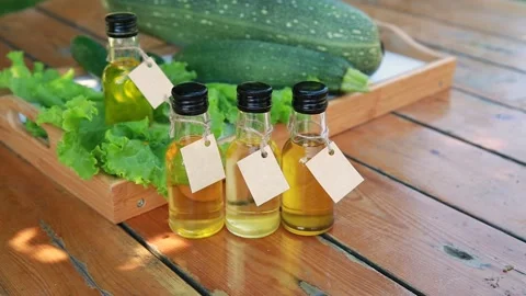 Four types of vegetable oil in small bottles with cardboard labels Stock Footage 169004799