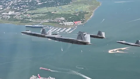 Four U.S. Air Force F-22 Raptors fly in formation over Charleston South Carolina Stock Footage 253997954