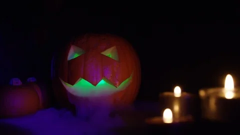 Four variations of carved orange halloween pumpkin in spooky decoration setting  Видео 117792503