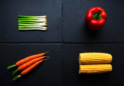 Four vegetables on slate base Stock Photos