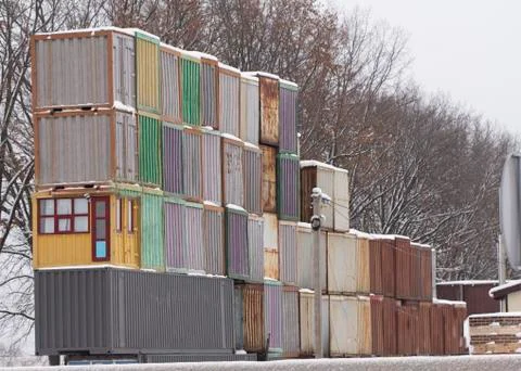 Four vertical rows of shipping containers that are different colors Stock Photos