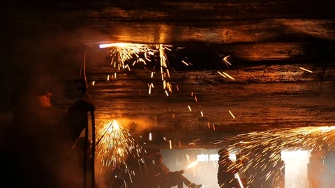 Four welders under the ship cut the metal in the smoke Stock Footage 87505348