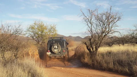 Four-wheel, 4x4, drives through a puddle and continues toward the horizon Stock-Footage 212611426