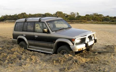Four wheel drive broken down on the beach Stock Photos