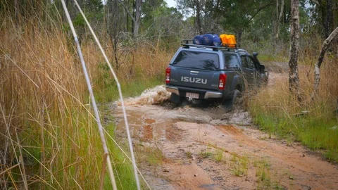 Four wheel drive going through muddy water from rear Stock Footage 119675369