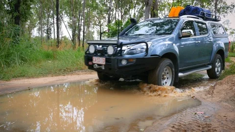 Four wheel drive going through muddy water Stock Footage 119675497