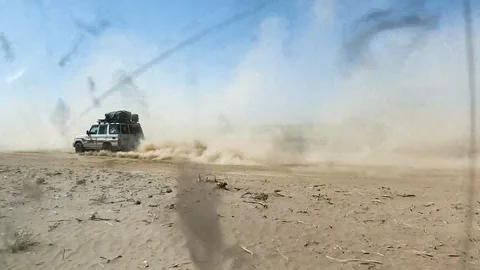Four wheel drives going fast on desert raisings clouds of dust, tc01 Stock Footage 102226048